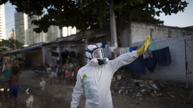 A Municipal Worker Gestures During An Operation To Combat The Aedes Aegypti Mosquitoes That Transmits The Zika Virus In Recife, Pernambuco State, Brazil, Tuesday, Jan. 26, 2016. Brazil's Health Minister Marcelo Castro Said That Nearly 220,000 Members Of Brazil's Armed Forces Would Go Door-To-Door To Help In Mosquito Eradication Efforts Ahead Of The Country's Carnival Celebrations. (Ap Photo/Felipe Dana)