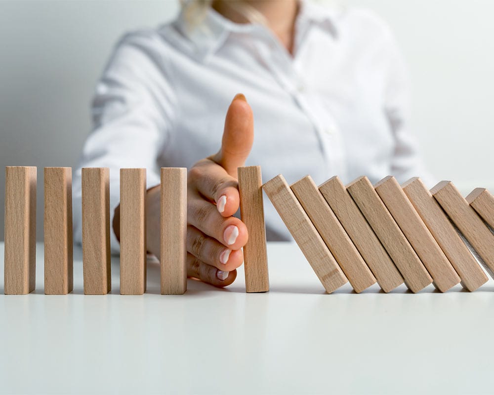 Businesswoman Halting The Domino Effect